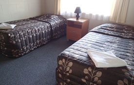 two single beds in the second room of 2-bedroom unit